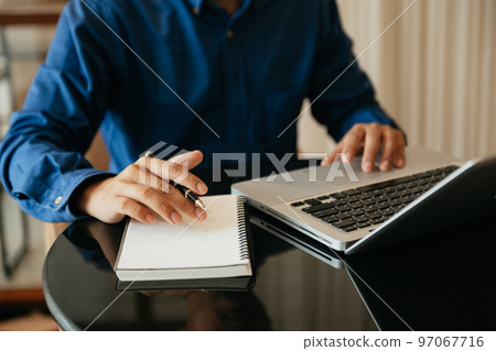 businesswoman hand working with new modern computer and writing on the notepad strategy diagram as concept businesswoman hand working with new modern computer and writing on the notepad strategy diagram as concept 97067716