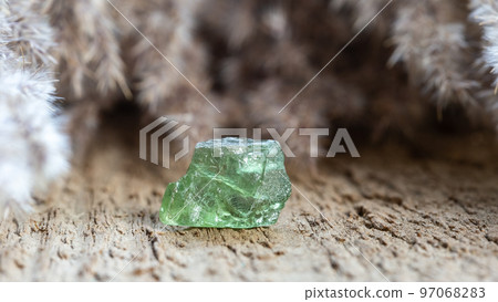 Apatite Crystal Healing Stone on Wood Background 97068283
