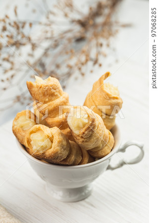 Pastry Tubes with Whipping Cream in the White Cup 97068285