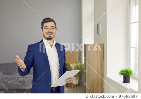 Portrait of professional realtor or real estate agent holding clipboard and smiling 97068697