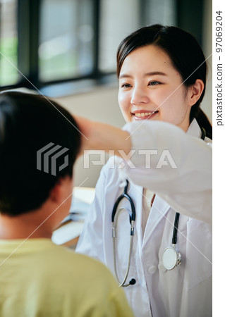 Young female doctor examining with her hand on her forehead 97069204