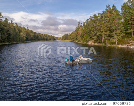 aerial footage couple Kayaking Boat tour on lake Ragnerudssjoen in Dalsland Sweden beautiful nature forest pinetree aerial footage couple Kayaking Boat tour on lake Ragnerudssjoen in Dalsland Sweden beautiful nature forest pinetree 97069725