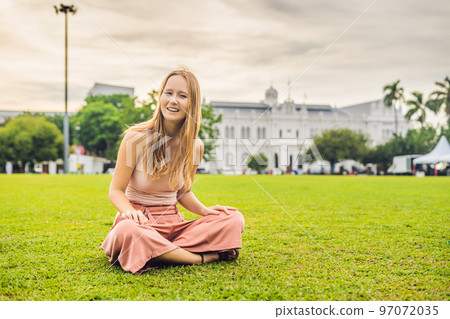 Young woman feeding an African Sacred ibis 97072035