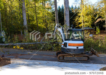 When tornado touched down trees were uprooted and fell into street, resulting in need for tractor to remove debris When tornado touched down trees were uprooted and fell into street, resulting in need for tractor to remove debris 97072048