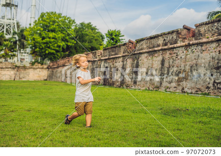 Young woman feeding an African Sacred ibis 97072073