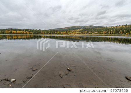 camping caravan near river autumn fall landscape along Ammarnas National Park in Lapland Sweden 97073466