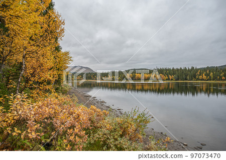 camping caravan near river autumn fall landscape along Ammarnas National Park in Lapland Sweden 97073470