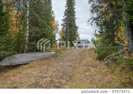 camping caravan near river autumn fall landscape along Ammarnas National Park in Lapland Sweden 97073472