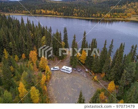 aerial view camping caravan near river autumn fall landscape along Ammarnas National Park in Lapland Sweden 97073479