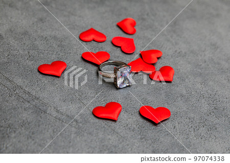 Will you marry me. Wedding ring many red hearts on concrete stone grey background. Engagement marriage proposal wedding concept. St. Valentine's Day postcard. Banner on valentines day 97074338
