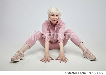 active elderly woman poses in the studio on a white background. fitness concept 97074477