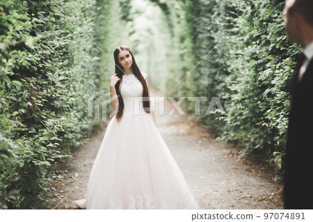 Lovely happy wedding couple, bride with long white dress Lovely happy wedding couple, bride with long white dress 97074891