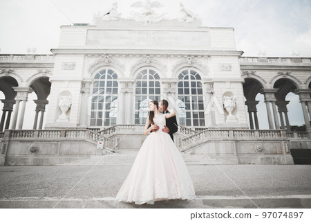Luxury wedding couple, bride and groom posing in the city of Vienna Luxury wedding couple, bride and groom posing in the city of Vienna 97074897