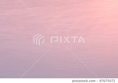 The surface of the lake dyed pink in the evening 97075072