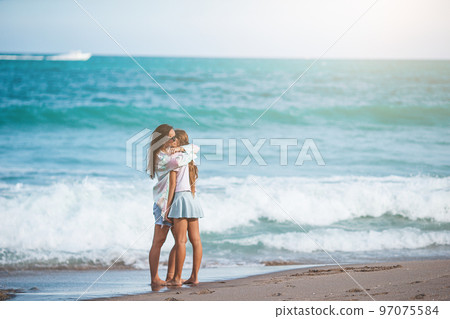 Adorable little girl and young mother on tropical white beach 97075584
