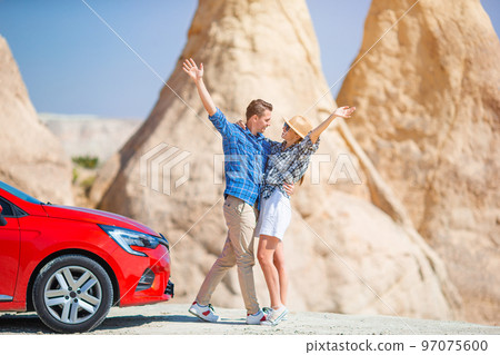 Family on car vacation. Happy couple travel by car in mountains. Family on car vacation. Happy couple travel by car in mountains. 97075600