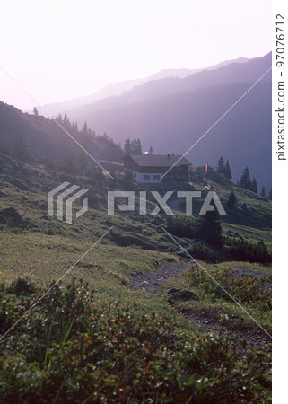 Natural landscape with high mountain peaks of the Rhaetikon in the Eastern Alps at the Luener Lake in Austria Natural landscape with high mountain peaks of the Rhaetikon in the Eastern Alps at the Luener Lake in Austria 97076712