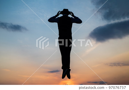 Break the rules. need the inspiration. man feel motivation. fly in sky. jumping man silhouette on sky background. confidence and success. concept of successful future. agile business. loneliness Break the rules. need the inspiration. man feel motivation. fly in sky. jumping man silhouette on sky background. confidence and success. concept of successful future. agile business. loneliness 97076737