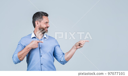 unshaven male employer in formalwear or office manager pointing finger on copy space, advertisement unshaven male employer in formalwear or office manager pointing finger on copy space, advertisement 97077101