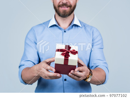 giftbox in hand of man in shirt, selective focus, boxing day giftbox in hand of man in shirt, selective focus, boxing day 97077102