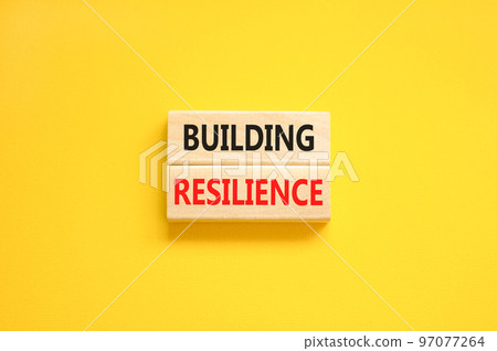 Building resilience symbol. Concept word Building resilience typed on wooden blocks. Beautiful yellow table yellow background. Business and building resilience concept. Copy space. 97077264