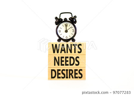Wants needs and desires symbol. Concept words Wants Needs Desires on wooden blocks. Black alarm clock. Beautiful white background. Business, psychological wants needs and desires concept. Copy space. 97077283