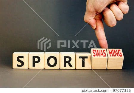 Sport or sportswashing symbol. Concept words Sport and Sportswashing on wooden cubes. Businessman hand. Beautiful grey table grey background. Business sport sportswashing concept. Copy space. Sport or sportswashing symbol. Concept words Sport and Sportswashing on wooden cubes. Businessman hand. Beautiful grey table grey background. Business sport sportswashing concept. Copy space. 97077336