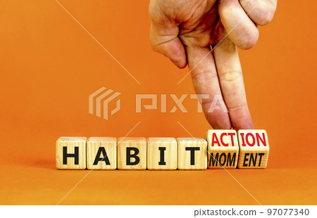 Habit action and moment symbol. Concept words Habit action Habit moment on wooden cubes. Businessman hand. Beautiful orange table orange background. Business habit action moment concept. Copy space. Habit action and moment symbol. Concept words Habit action Habit moment on wooden cubes. Businessman hand. Beautiful orange table orange background. Business habit action moment concept. Copy space. 97077340