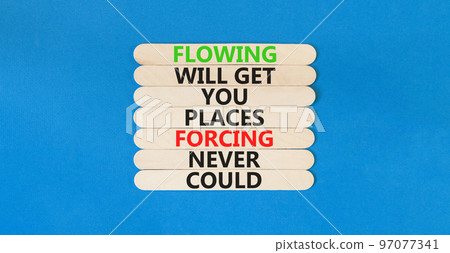 Flowing symbol. Concept words Flowing will get you places forcing never could on wooden sticks. Beautiful blue table blue background copy space. Business motivational flowing concept. 97077341