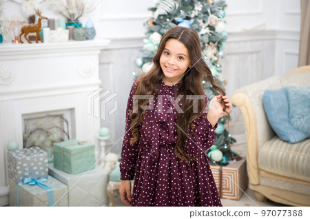 Christmas. Kid enjoy the holiday. The morning before Xmas. New year holiday. Happy new year. little child girl likes xmas present. small happy girl at christmas. Home is the best place in the world 97077388