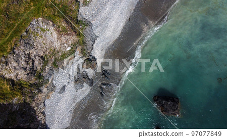 Beautiful rocky beach on the south coast of Ireland near Clonakilty. The picturesque coast of the Celtic Sea. Sea surf. Turquoise waters of the Atlantic. Drone point of view. 97077849