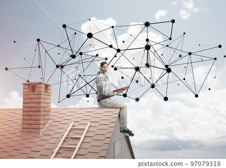 Man on brick roof reading book and concept of social connection Man on brick roof reading book and concept of social connection 97079318