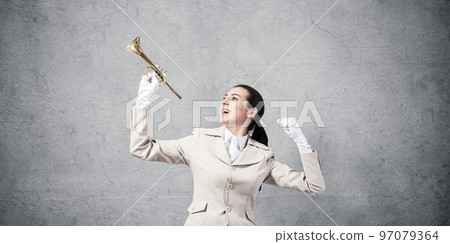 Beautiful woman holding trumpet brass overhead Beautiful woman holding trumpet brass overhead 97079364