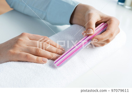 Woman using nail file and create nails shape 97079611