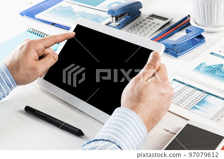 businessman with a tablet, works in the office 97079612