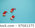 Christmas, New Year blue stylish flat frame with tangerines in santa hats. Winter holiday composition. View from above. 97081375