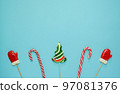 Christmas or winter composition. Frame made of snowflakes and candy trees on a red background. Christmas, winter, new year concept. Flat lay 97081376