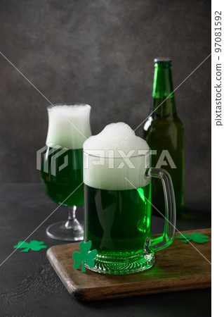 Patrick's day traditional green beer and bottle on black background. Patrick's day traditional green beer and bottle on black background. 97081592