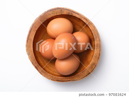 Brown fresh raw eggs in wooden bowl plate on white background. 97081624