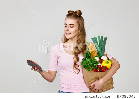 woman holding shopping eco-friendly paper bag full of groceries 97082045