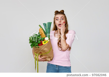 surprised caucasian vegetarian woman hold paper bag with groceries surprised caucasian vegetarian woman hold paper bag with groceries 97082046