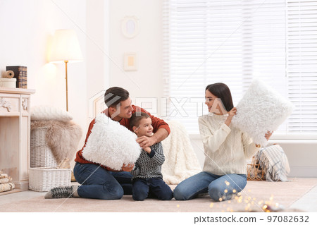 Happy family having pillow fight at home. Winter vacation 97082632