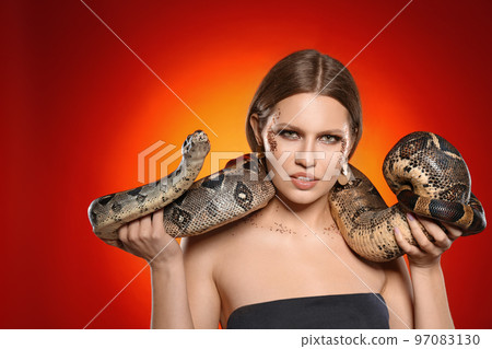 Beautiful woman with boa constrictor on bright colorful  background 97083130