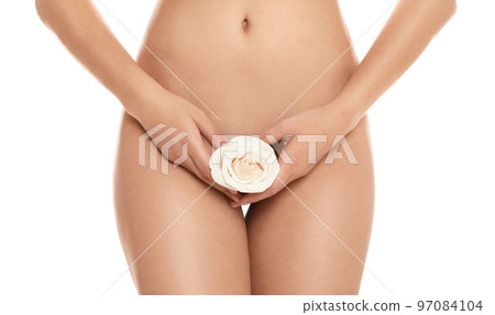 Woman with feather showing smooth skin after bikini epilation on pink background 97084104