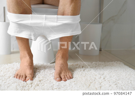 Woman with feather showing smooth skin after bikini epilation on pink background Woman with feather showing smooth skin after bikini epilation on pink background 97084147