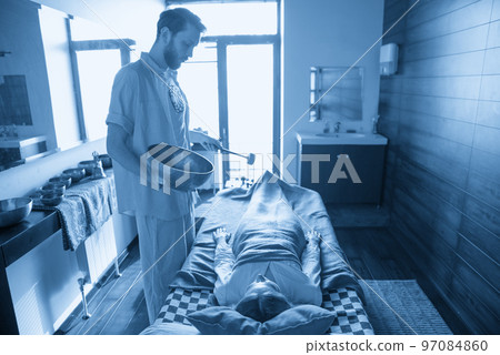 Tibetan singing bowls in sound therapy in spa center 97084860