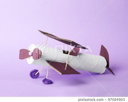 Toy plane made of toilet paper hub on lilac background Toy plane made of toilet paper hub on lilac background 97084903