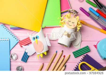 Owl and angel made of toilet paper hub among stationery on pink wooden table, flat lay Owl and angel made of toilet paper hub among stationery on pink wooden table, flat lay 97084926