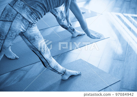 Yoga Class, Group of People Relaxing and Doing Yoga pose. Wellness and Healthy Lifestyle. 97084942