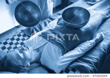 Tibetan singing bowls in sound therapy in spa center 97084944